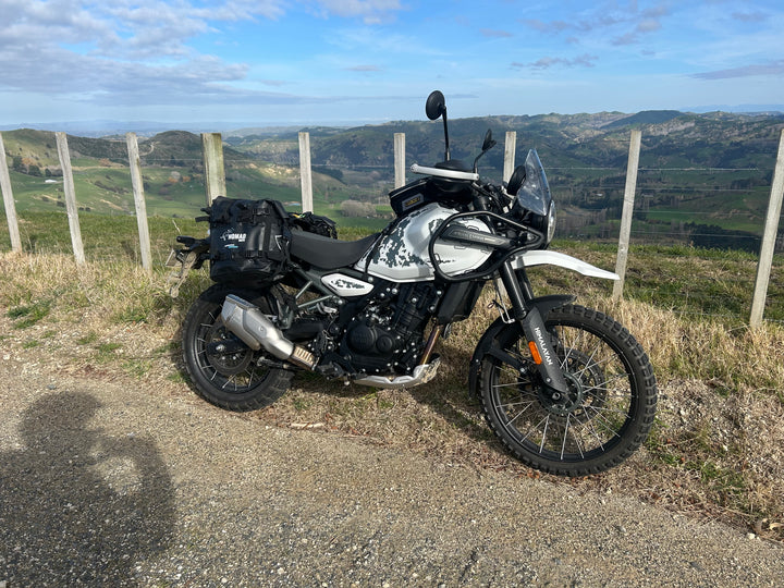 ADV bike with soft luggage on a gravel road