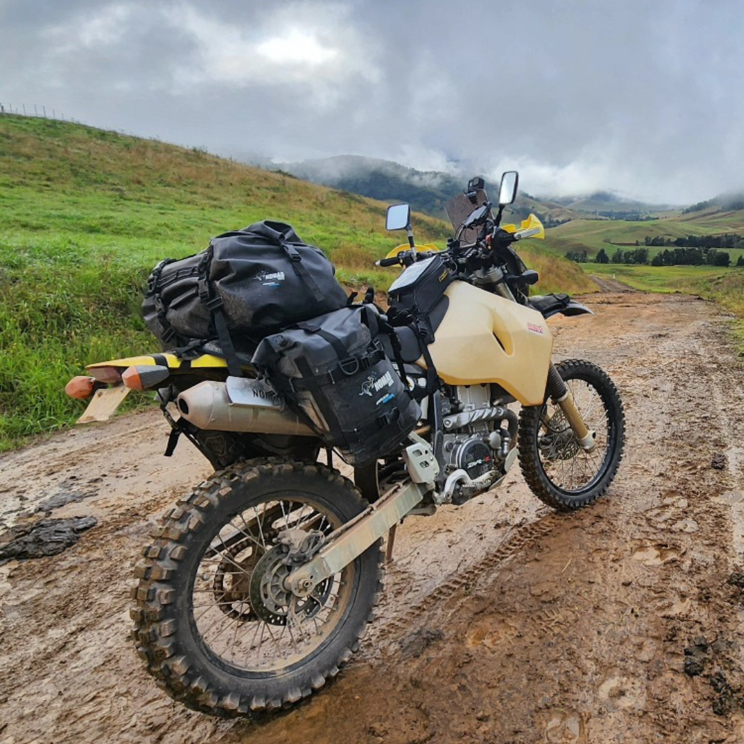 Adventure motorcycle on muddy dirt road