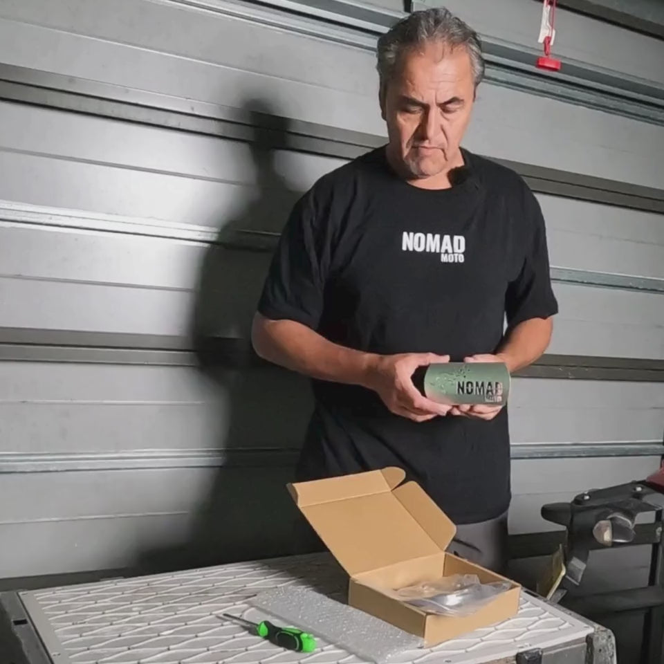 Man unboxing motorcycle exhaust guard kit