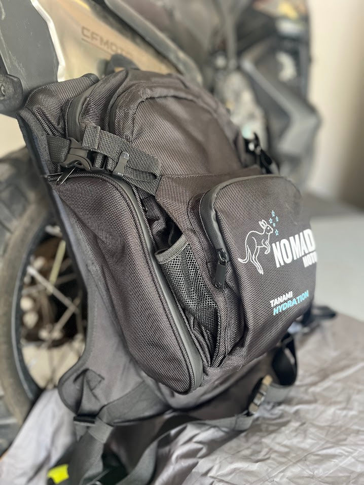 Black motorcycle saddlebag with Nomad logo attached to a motorcycle.