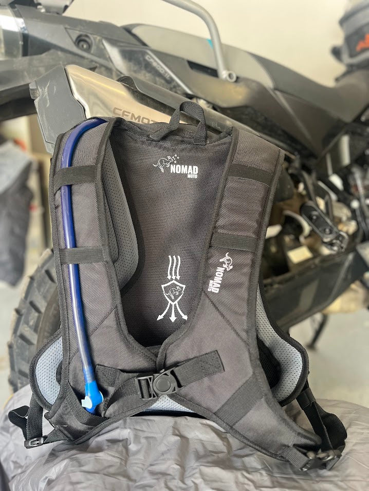 Gray hydration backpack with visible brand logo on a motorcycle.